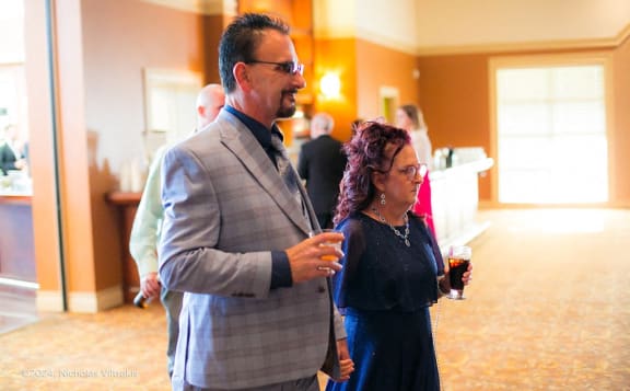 a man and a woman standing in a room talking