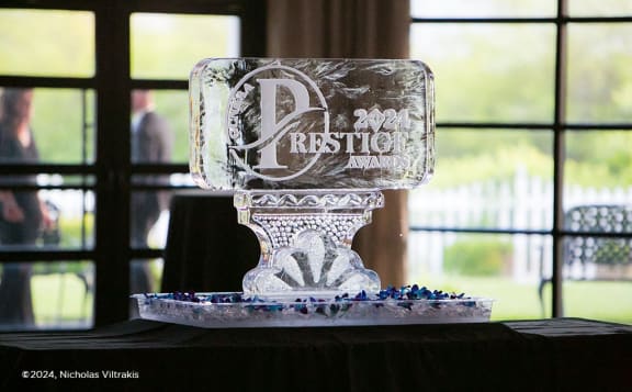 a frosted glass cake holder on top of a table