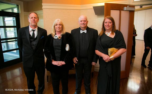 a group of people posing for a picture in a room