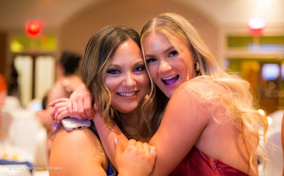 two girls hugging each other at a party
