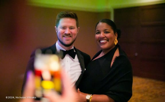 a bride and groom posing for a picture at a wedding