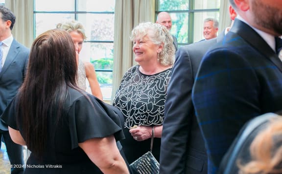 a group of people standing around in a room