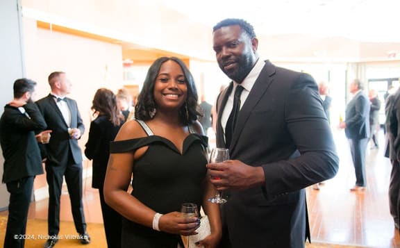 a man and woman posing for a picture at a networking event