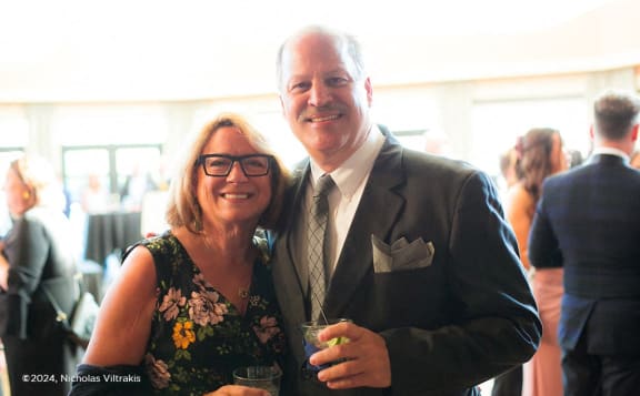a man and a woman posing for a picture at a party