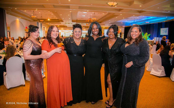 a group of women posing for a photo at a party
