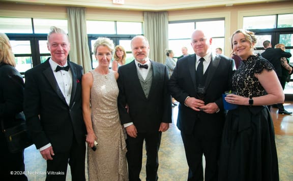 a group of people posing for a picture at a formal event