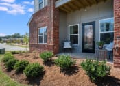 Thumbnail 28 of 78 - Exterior view of Pointe at Prosperity Village with beautiful front lawn and private patio in Charlotte, NC