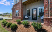 Thumbnail 28 of 78 - Exterior view of Pointe at Prosperity Village with beautiful front lawn and private patio in Charlotte, NC