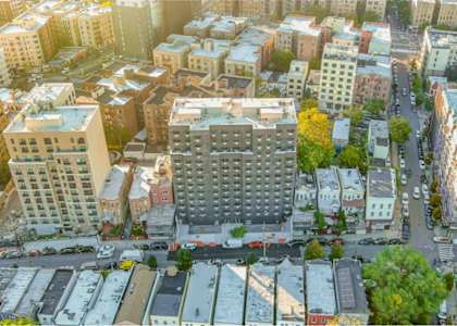 an aerial view of a city with lots of buildings and trees