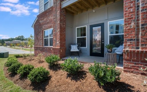 Exterior view of Pointe at Prosperity Village with beautiful front lawn and private patio in Charlotte, NC