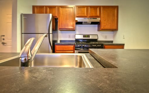 Kitchen counter top with stainless steel appliances and wooden cabinets