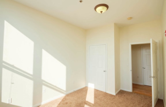 Bedroom with carpeted floors and closet