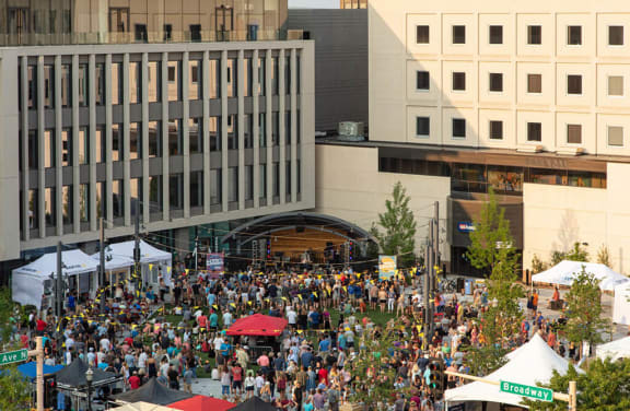 An aerial view of a crowd of people at a festival in a city at Kesler Apartments in Downtown Fargo, Fargo, ND 58102
