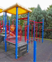 a colorful playground with benches and a swing set at Troutdale Terrace, Troutdale, OR 97060