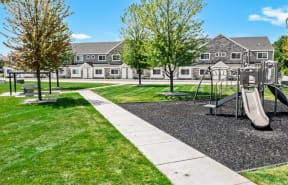 a playground in a park with a house in the background