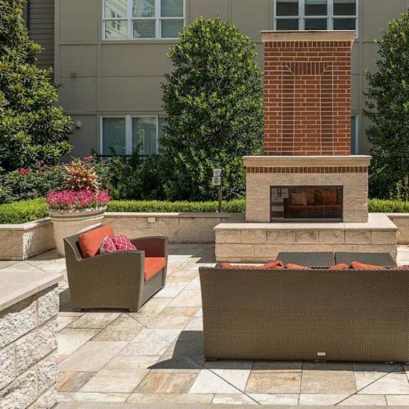 An outdoor firepit surrounded by seating at Cityplace Heights. 