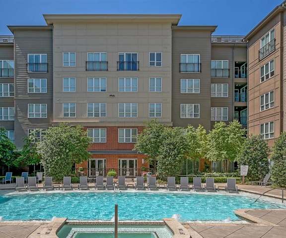 The outdoor pool with pool chairs, tables, and chairs at Cityplace Heights. 