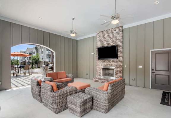 a living room filled with furniture and a flat screen tv