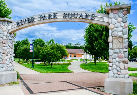 A stone archway with the words "River Park Square" on it.
