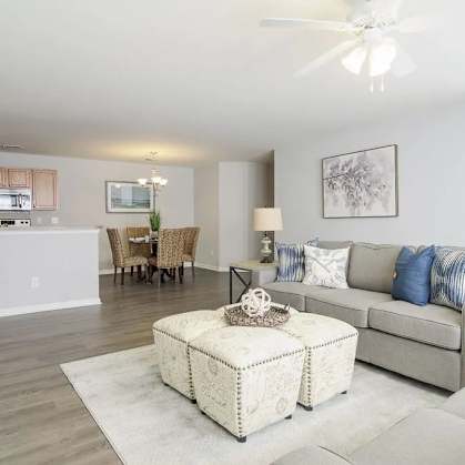 A living room with a grey couch and a white coffee table.