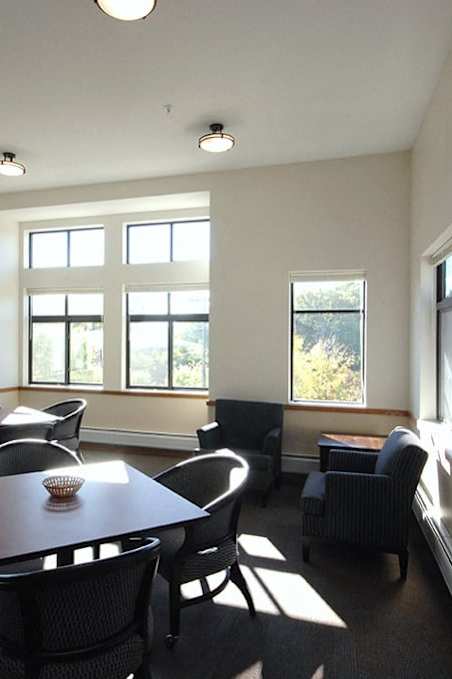 A dining room with a table and chairs.