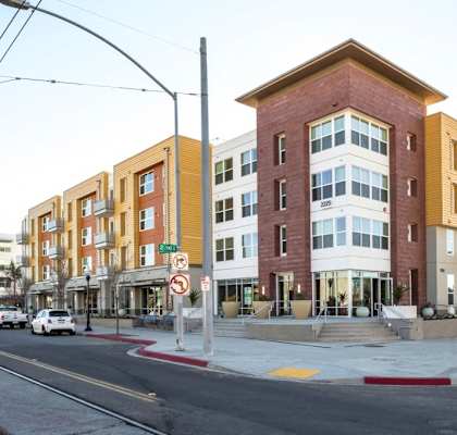 a new apartment building on the corner of a city street