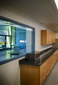 A kitchen with a white refrigerator and a stainless steel sink.