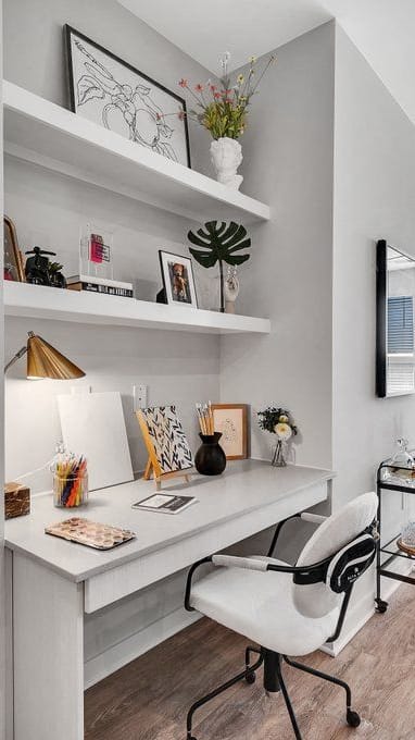 a home office with a desk and a living room