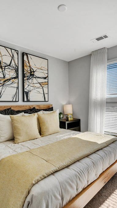 a bedroom with a bed and some windows