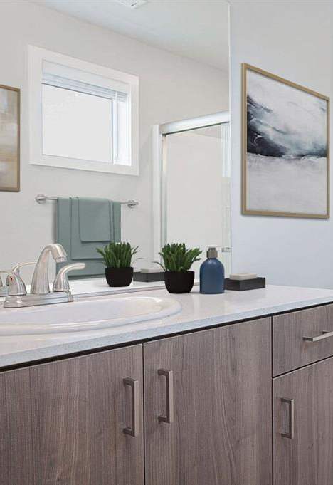 A bathroom with a toilet, sink, and shower.