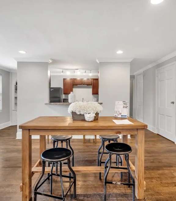 A home gym with a variety of equipment including a squat rack, bench, and exercise balls.
