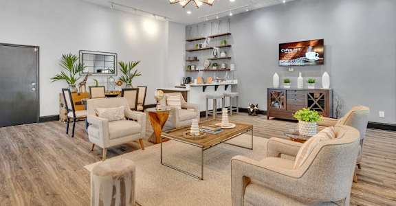 A living room with a large couch, a chair, and a coffee table.