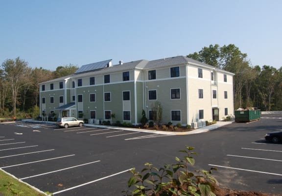an apartment building with solar panels on the roof