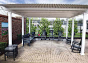 Thumbnail 3 of 5 - a patio with benches and a pavilion