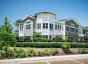 Thumbnail 5 of 5 - a row of white houses with a garden in front of them