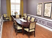Thumbnail 5 of 6 - a dining room with a wooden table and chairs