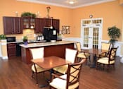 Thumbnail 1 of 5 - a kitchen and dining room with a table and chairs