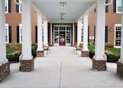 Thumbnail 1 of 5 - the front porch of a building with columns and a red door