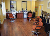 Thumbnail 3 of 5 - a salon room with chairs and a barbershop