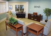 Thumbnail 4 of 5 - a living room with a couch and chairs and a table