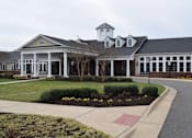 Thumbnail 5 of 5 - the front of a building with a driveway and a sidewalk