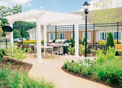 Thumbnail 2 of 5 - a patio with a table and chairs under a white canopy