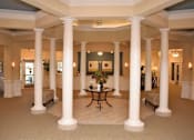 Thumbnail 2 of 5 - a large lobby with columns and a table