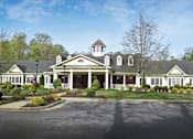Thumbnail 3 of 3 - the front of a house with a porch and a driveway