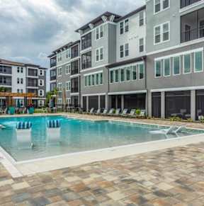 a conference room with a desk and chairs and a mirror at The Oasis at 301 Apartments, Riverview, FL