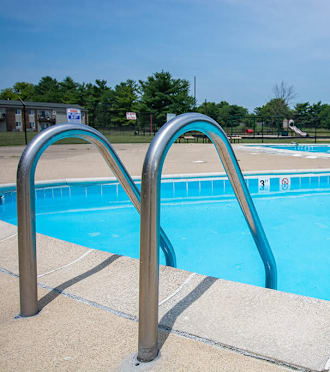 a swimming pool with a metal railing