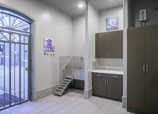 Pet Wash Station with white floors, brown cabinets and door to outside