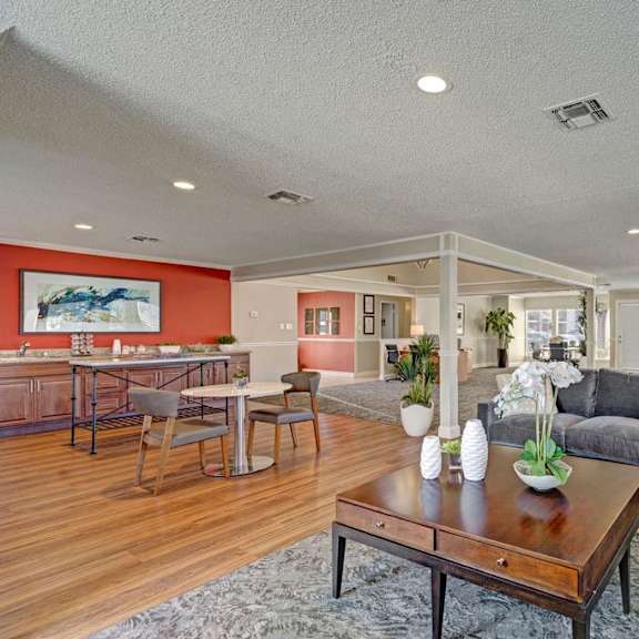 The community room at Acacia Park, with couches, chairs, and tables. 
