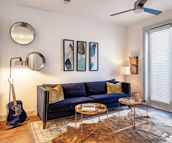 a living room with a couch and a guitar in it