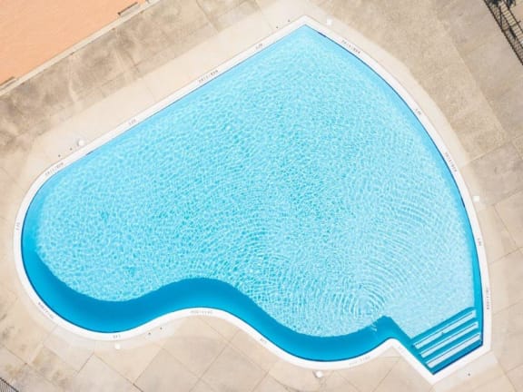 a large swimming pool with blue water in it